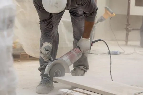 Concrete edge being cut with an angle grinder