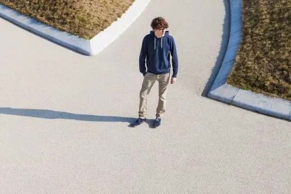 Smooth pale concrete paving with a curved edge to a garden bed